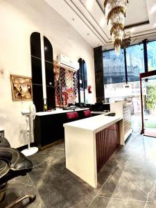 a room with a kitchen with a counter and some windows at Hotel Red Stone - 3 Mins from Railway Station and 5 Mins from Metro in New Delhi