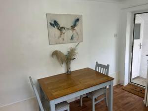 a dining room table with two birds on the wall at Emsworth Studio - With Hot tub only Oct to April in Emsworth