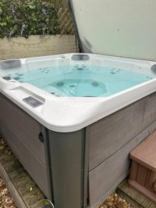 a jacuzzi tub sitting in a building at Emsworth Studio - With Hot tub only Oct to April in Emsworth