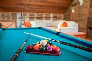a pool table with balls and cuesticks on it at 15 Mins to U of A - Pool & Hot Tub in Fayetteville