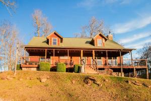 a large house on top of a hill at 15 Mins to U of A - Pool & Hot Tub in Fayetteville