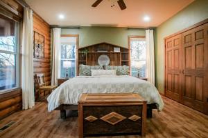 a bedroom with a bed and a table in it at 15 Mins to U of A - Pool & Hot Tub in Fayetteville