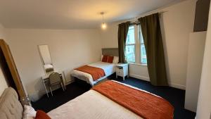a hotel room with two beds and a window at Saint Paul 05 in Bristol