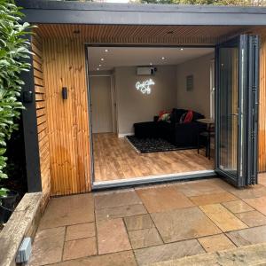 a sliding glass door leading into a living room at Leeds Airport & Trinity Uni Guest House in Leeds