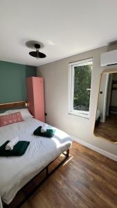 a bedroom with a bed with two towels on it at Leeds Airport & Trinity Uni Guest House in Leeds
