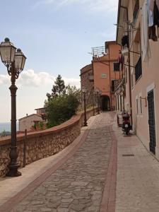 a cobblestone street with a street light and buildings at La Colonnina in Minturno +8 photos