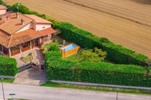 an aerial view of a house with a field at Casa Emma - Private house with pool in Castiglione del Lago