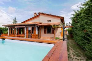 a house with a swimming pool in front of a house at Casa Emma - Private house with pool in Castiglione del Lago