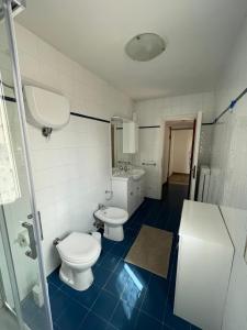 a bathroom with two toilets and a sink at Palazzo Marini in Spoleto