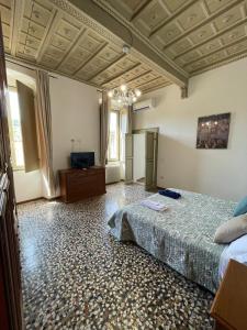 a large bedroom with a bed and a television at Palazzo Marini in Spoleto +7 photos