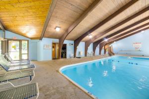 Una gran piscina en un edificio con sillas. en 2 Fire Pits and Lake Access Cozy Mecosta Getaway!, en Mecosta