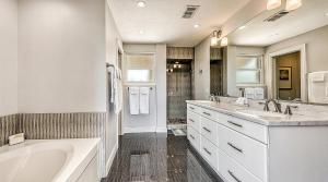 a white bathroom with two sinks and a tub and a bath tub at Siesta Sunset - 524 (PH) in Siesta Key +34 photos