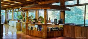 a bar in a room with a lot of windows at Altos quiñenahuin lodge in Curarrehue