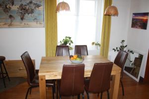 a dining room table with chairs and a bowl of fruit at Hearth House - Character Family Home in Hastings