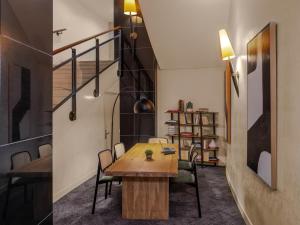 a room with a table and chairs and a staircase at Mercure Paris Gare Montparnasse TGV in Paris