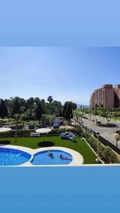 a pool in a park with two people in it at Oropesa summer in Oropesa del Mar