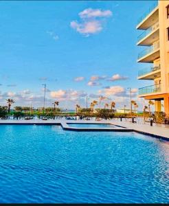 a large swimming pool in front of a building at بورتو سعيد شاليهات لإيجار من المالك in Port Said