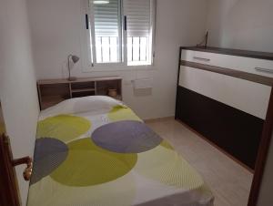 a bedroom with a bed with a colorful blanket at Oropesa summer in Oropesa del Mar +39 photos