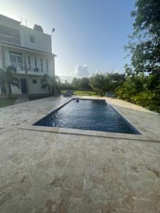 a swimming pool in front of a building at Jeda Village in Higuey