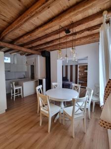a dining room with a white table and chairs at Olga's Paradise in Santa Croce del Lago