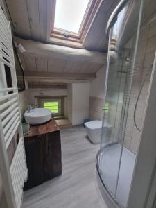 a bathroom with two sinks and a glass shower at Olga's Paradise in Santa Croce del Lago +6 photos