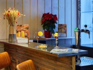 a bar with two glasses of wine on a counter at Ibis Sallanches Porte du MontBlanc in Sallanches