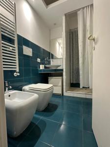 a bathroom with a white toilet and a sink at Bed&BikeRome LA CERQUETTA in Rome