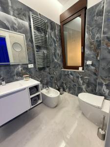 a bathroom with a sink and a toilet and a mirror at SN Luxury Room & Spa in Foggia +18 photos
