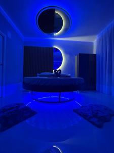 a blue room with a bed with a blue light at SN Luxury Room & Spa in Foggia