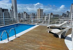 a balcony with a swimming pool on top of a building at Manaíra Flat 206 Em frente ao shopping Manaíra in João Pessoa