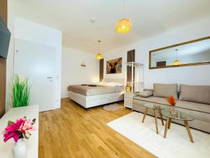 a living room with a bed and a couch at Katys Cozy Corner - Self CheckIn in Graz