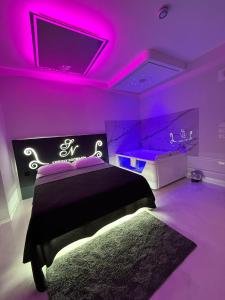 a purple bedroom with a bed and a tub at SN Luxury Room & Spa in Foggia