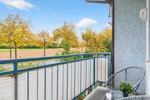 a balcony with a view of a field and trees at NEW-Tina in Buchen