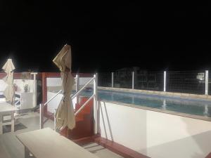 a view of a swimming pool on a boat at night at AK Guesthouse in Maputo
