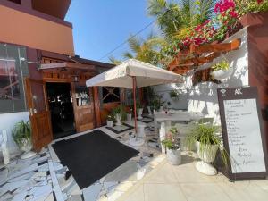 a patio with an umbrella and a table at AK Guesthouse in Maputo