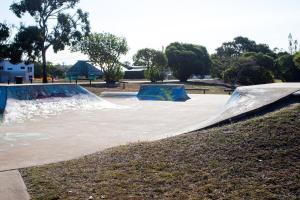 a skate park with a skateboard ramp in a park at Coastal Escape in North Coast