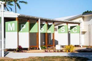 a building with green and white banners on it at Coastal Escape in North Coast