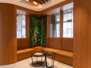 a waiting room with a large green wall at Mercure Colmar Centre Unterlinden in Colmar +79 photos