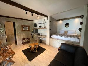 a bedroom with a bed and a desk and a couch at Saboga Lodge in Saboga +142 photos