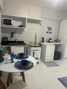a kitchen with a table with plates on it at Manaíra Flat 206 Em frente ao shopping Manaíra in João Pessoa