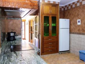 a kitchen with a white refrigerator in a room at Chalet con piscina privada solo familias y parejas in Roche +45 photos