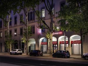 a group of cars parked in front of a building at Aparthotel Adagio Lyon Patio Confluence in Lyon