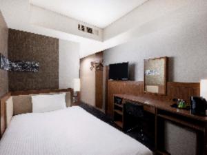 a hotel room with a bed and a television at ibis Styles Tokyo Ginza in Tokyo