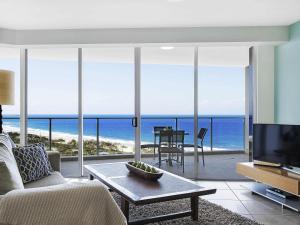a living room with a view of the ocean at The Sebel Maroochydore in Maroochydore
