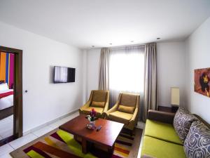 a living room with a couch and a table at Ibis Styles Accra Airport in Accra