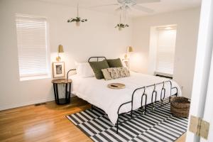 a bedroom with a bed and a rug at Victorian Gem Steps from Main St - Sleeps 9 & Pets in St. Charles +24 photos