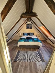 a bedroom with a bed in a attic at R&R on Chlamys Langezandt Fisherman's Village in Struisbaai +22 photos