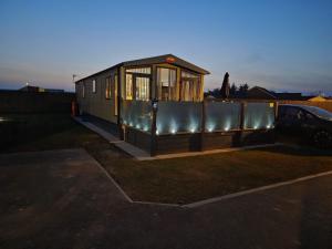 a tiny house is parked in a parking lot at Skegness retreats The Retreat 20 Golden Palm Resort chapel st leonards in Chapel Saint Leonards