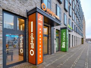 a building with signs on the side of a street at Aparthotel Adagio Access Kiel City in Kiel