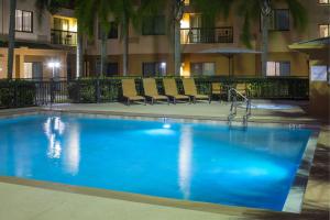 a swimming pool in a hotel at night at Courtyard by Marriott Daytona Beach Speedway/Airport in Daytona Beach